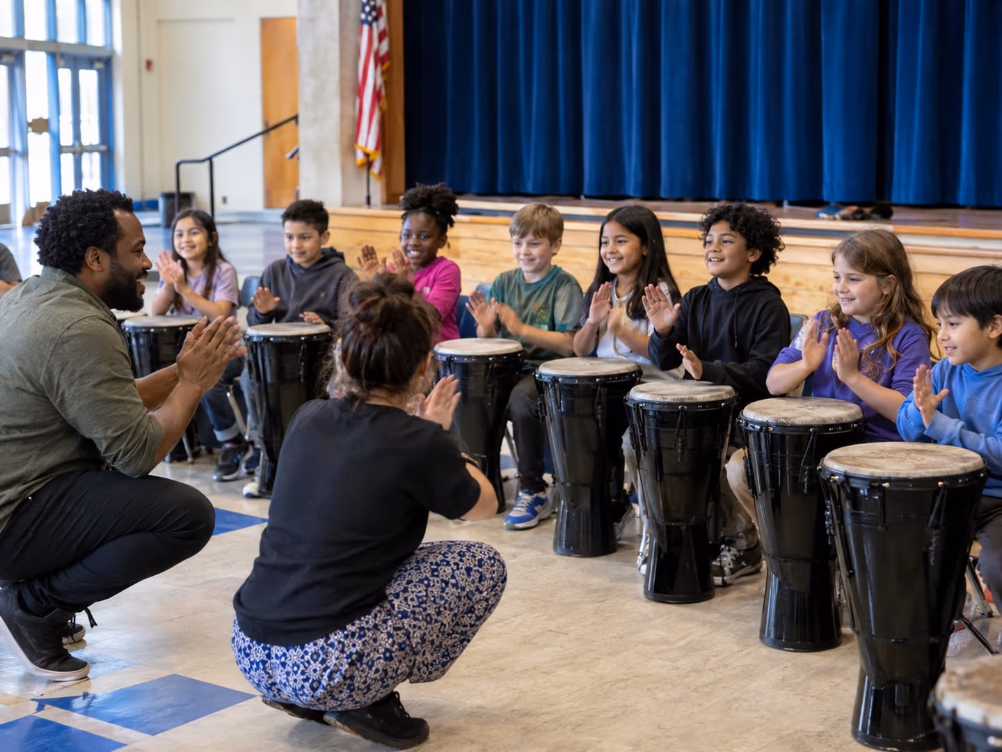 Illustration: a teaching artist leads a school hall full of children at drums. An AI recreation with fictional participants.